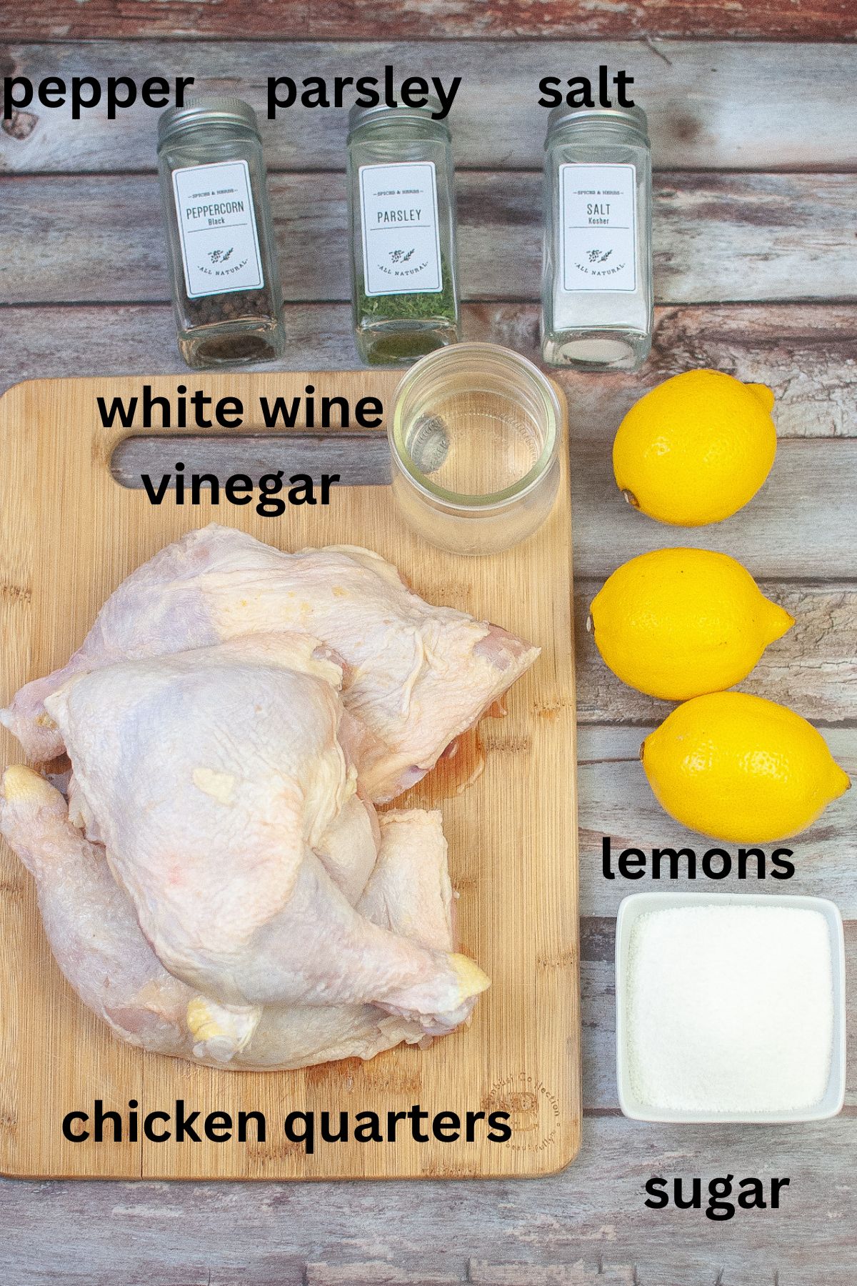 pepper, parsley, salt, white wine vinegar, lemons, sugar, and chicken quarters on a wooden background labelled with text