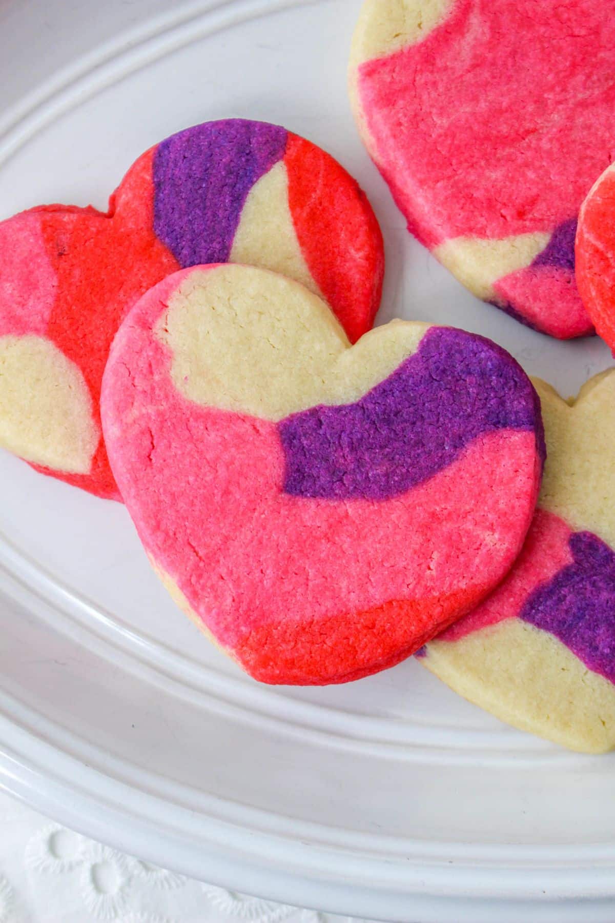 marble heart sugar cookies on a white plate