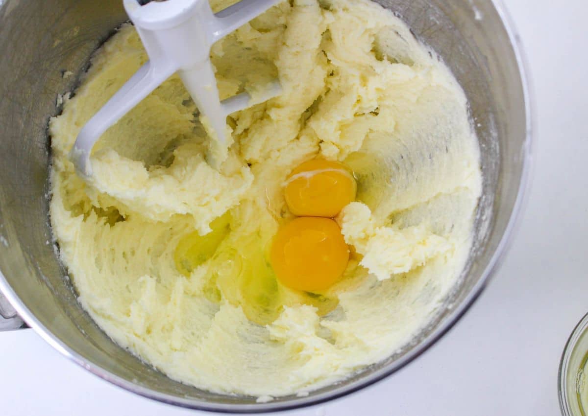 butter, sugar and eggs in a stainless steel mixing bowl