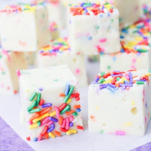 squares of funfetti fudge on a white and purple background