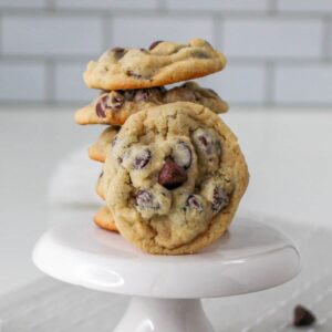 six chocolate chip cookies on a white cupcake stand