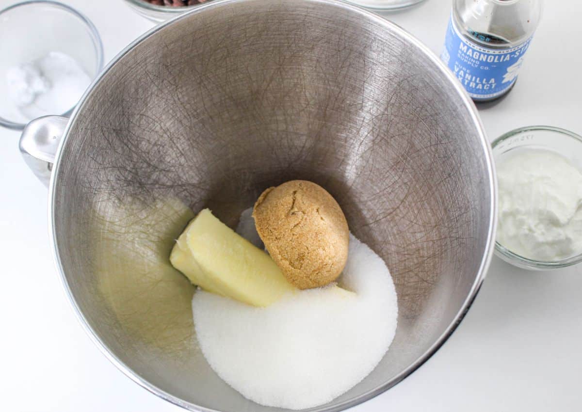 butter, brown sugar, and sugar in a stainless steel mixing bowl