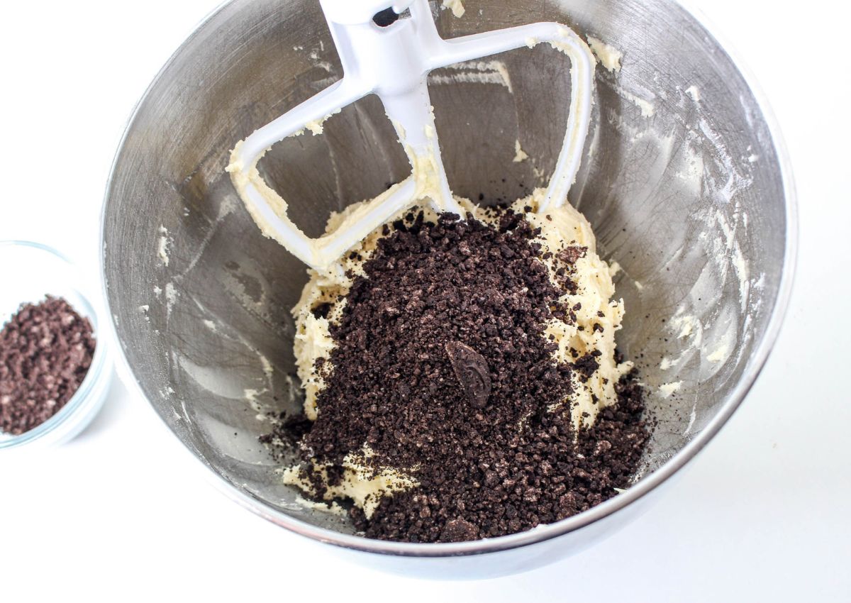 crushed oreo cookies being foled into cookie dough