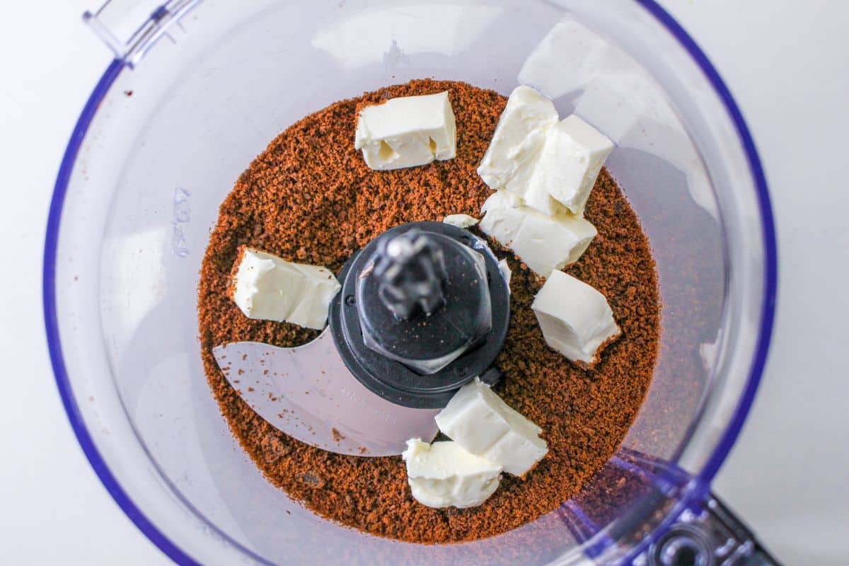 cookie crumbs and cream cheese in a food processor