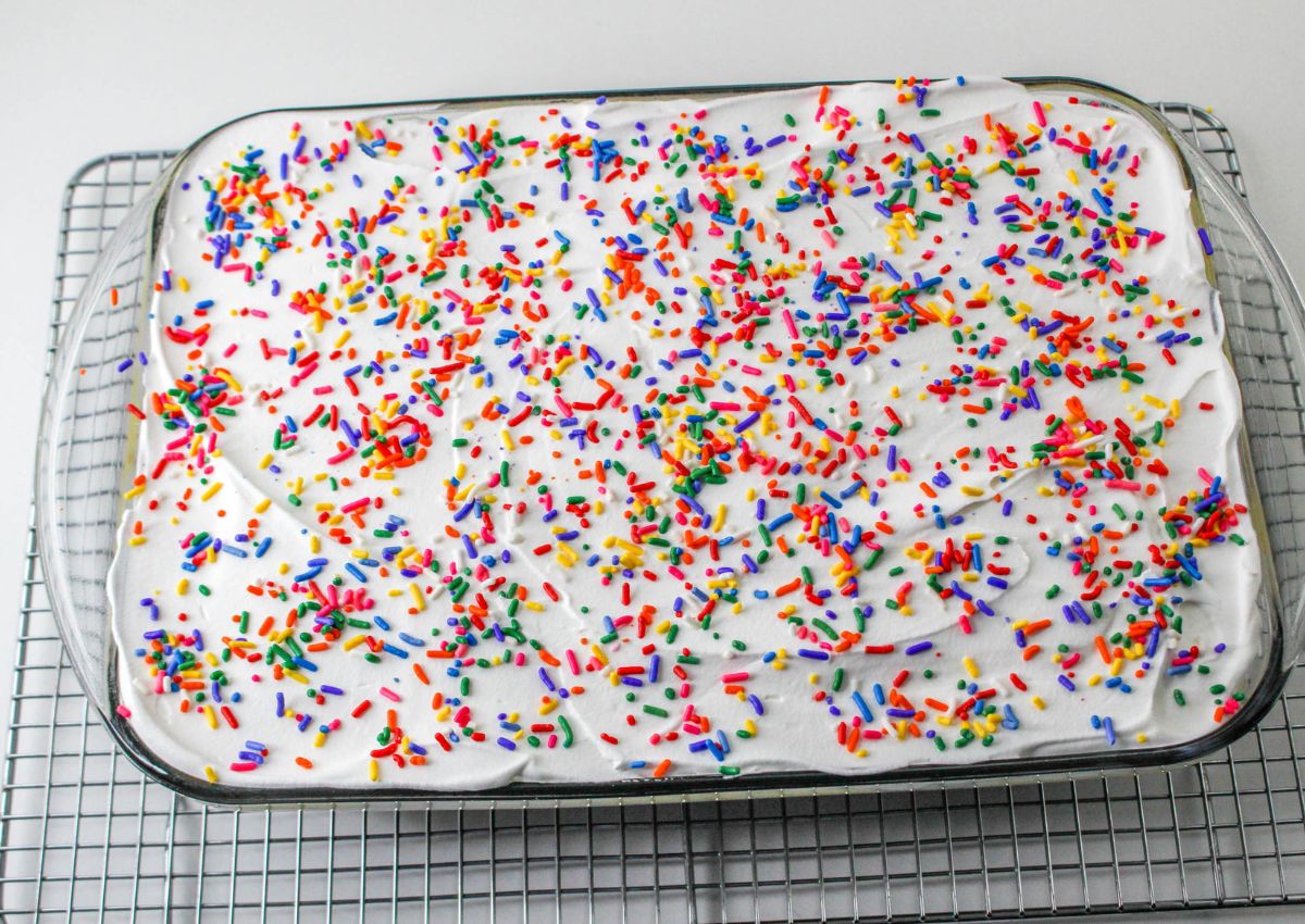 finished funfetti lush in a glass baking dish on a wire cooling rack