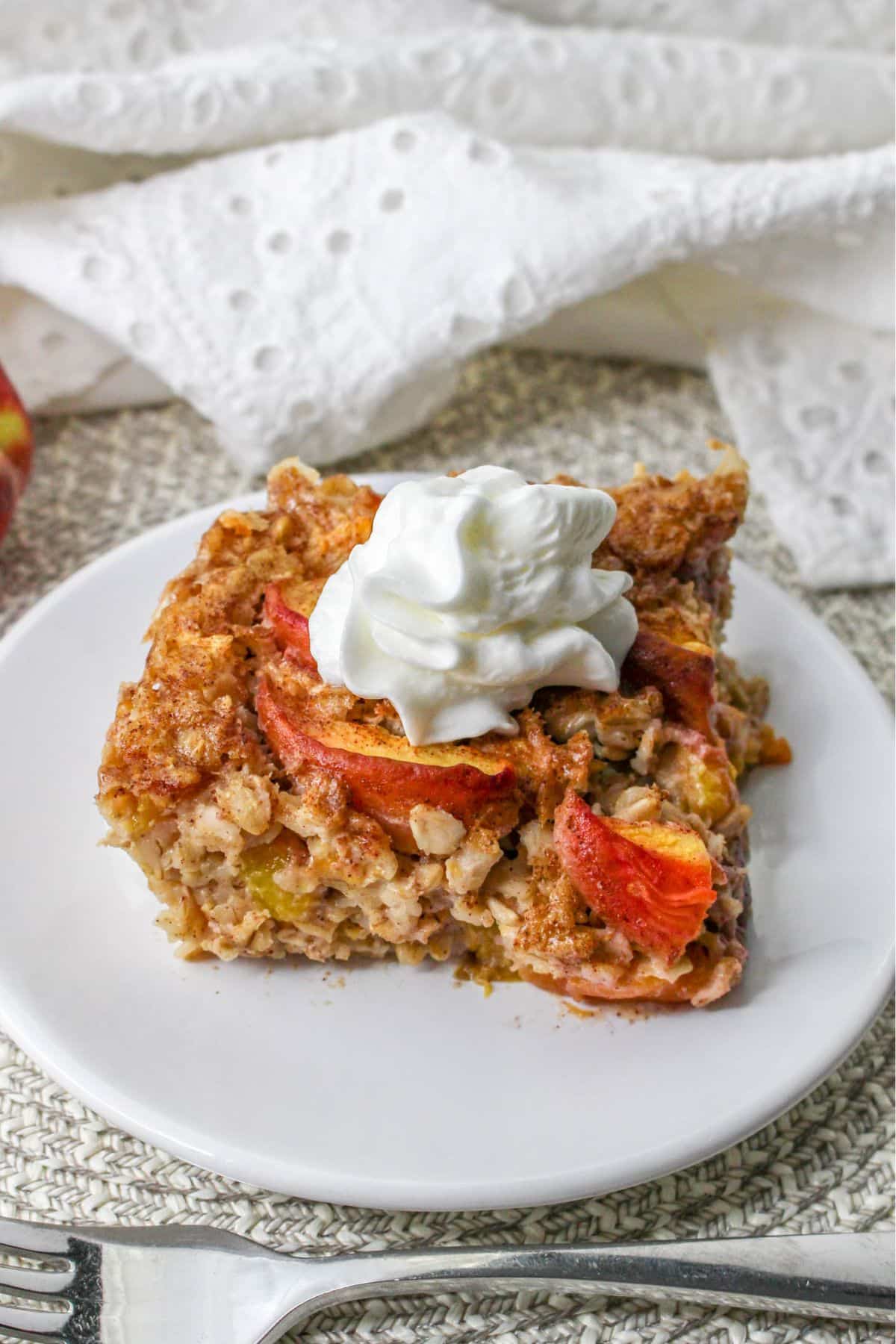 slice of peach baked oatmeal on a white plate