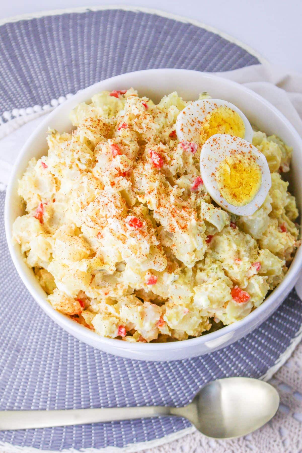 white bowl filled with pimento potato salad and topped with hard boiled eggs