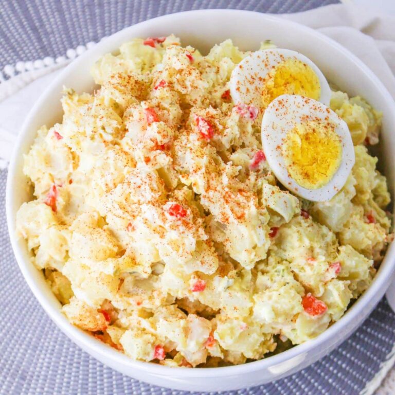 white bowl filled with pimento potato salad topped with hard boiled eggs
