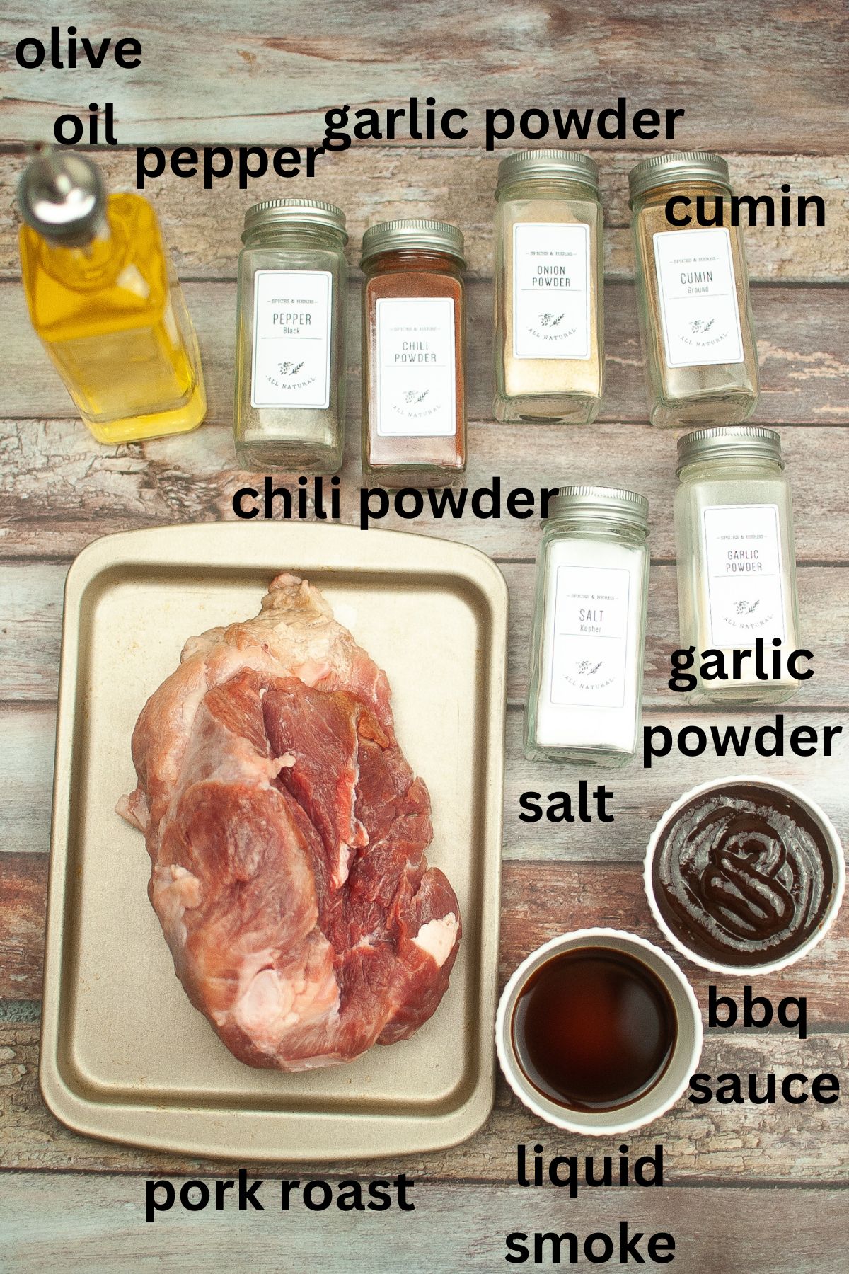 olive oil, pepper, garlic powder, cumin, chili powder, salt, garlic powder, bbq sauce, liquid smoke and pork roast on a wooden background
