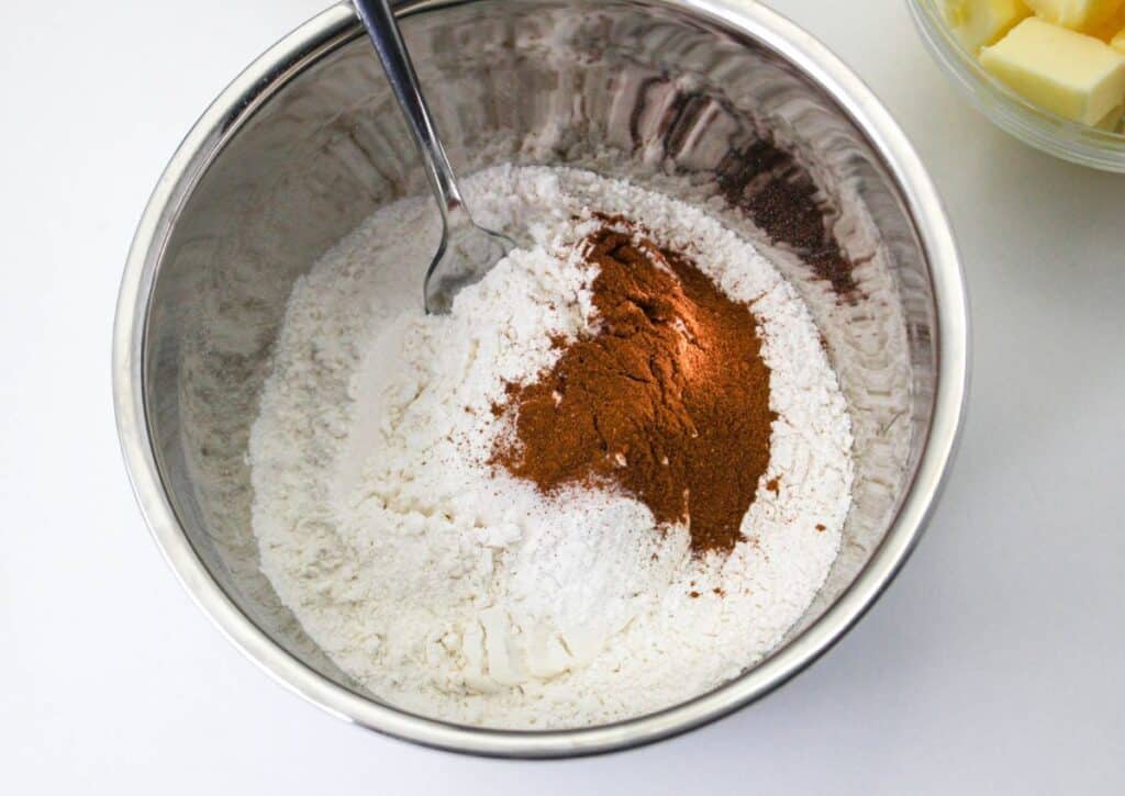 flour, salt, baking powder, baking soda, cinnamon and apple pie spice in a stainless steel mixing bowl