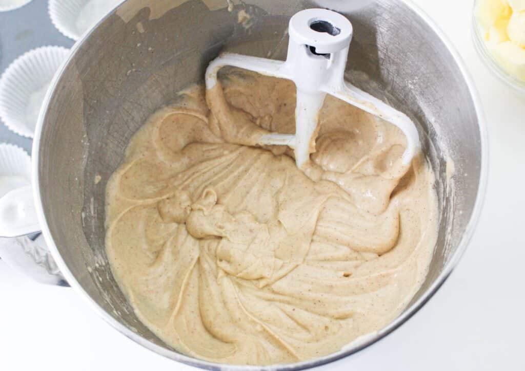 cinnamon cupcake batter in a stainless steel mixing bowl