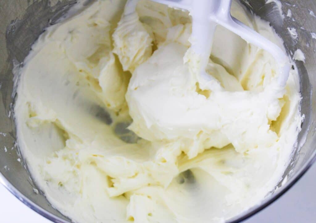 buttercream frosting being made in a stand mixer