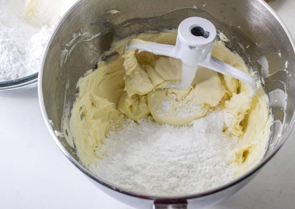 cream cheese, vanilla extract, and powered sugar in the bowl of a stand mixer