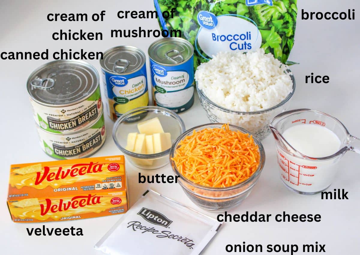 cans of chicken, cream of chicken soup, cream of mushroom soup, frozen broccoli, rice, milk, butter, cheddar cheese, Velveeta, and onion soup mix on a white background