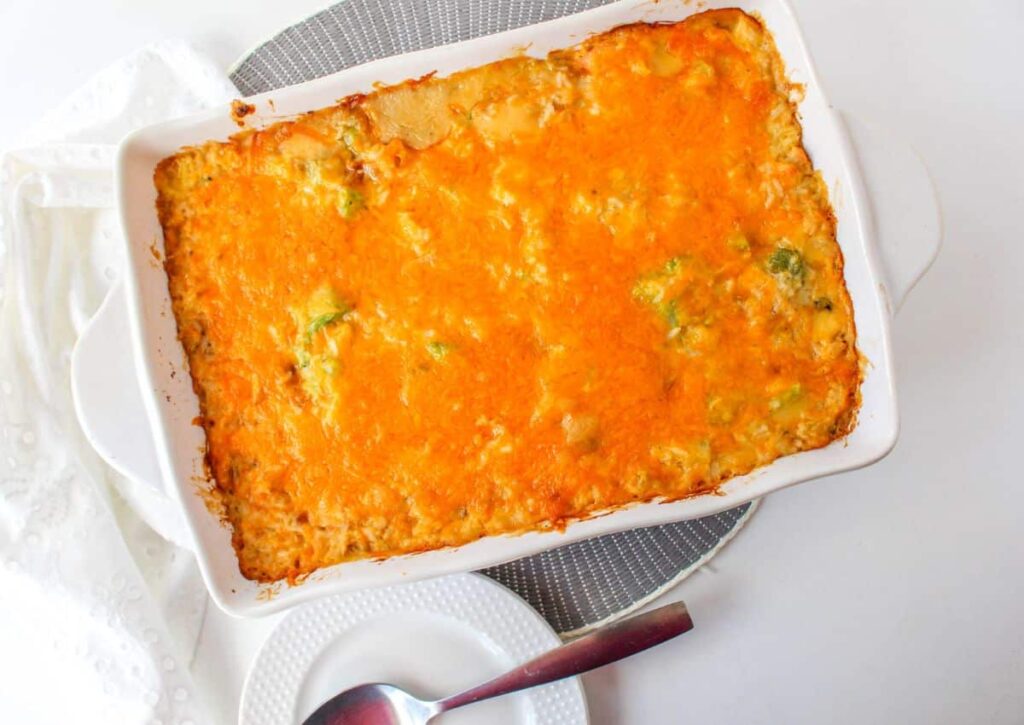 white casserole dish filled with baked chicken broccoli rice casserole