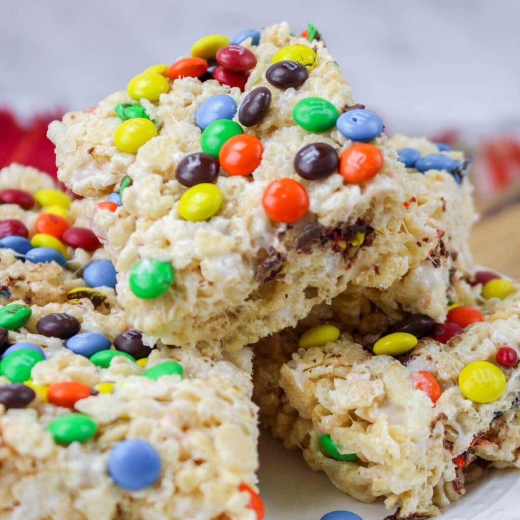 close up of rice krisipes treats stacked on a white plate