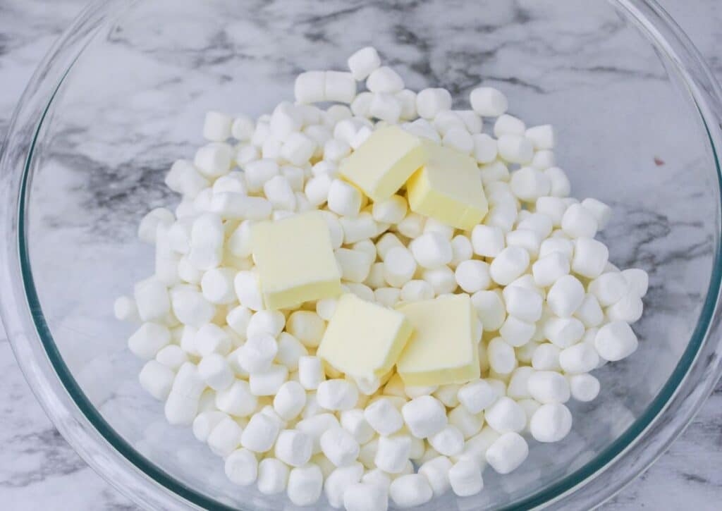 mini marshmallows and pats of butter in a glass bowl