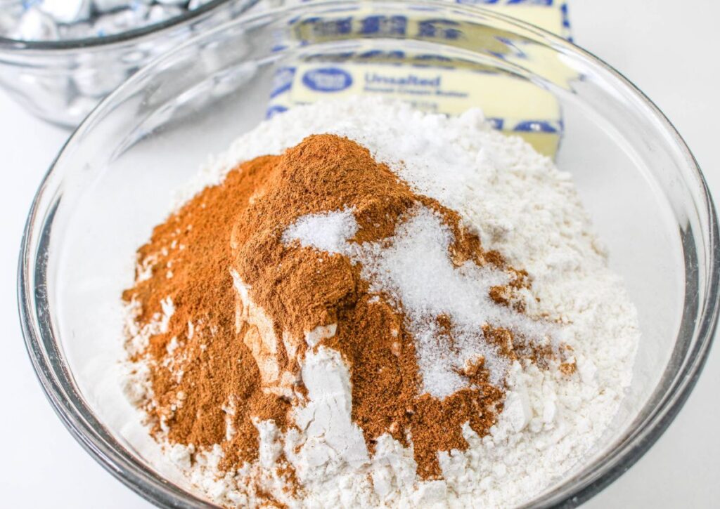 flour, sugar, cinnamon in a glass mixing bowl