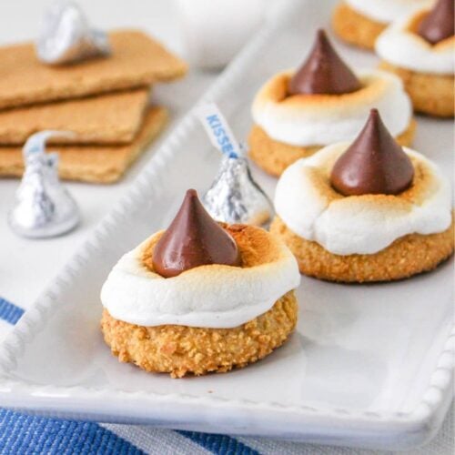 smores blossom cookies on a plate platter on top of a blue and white kitchen towel