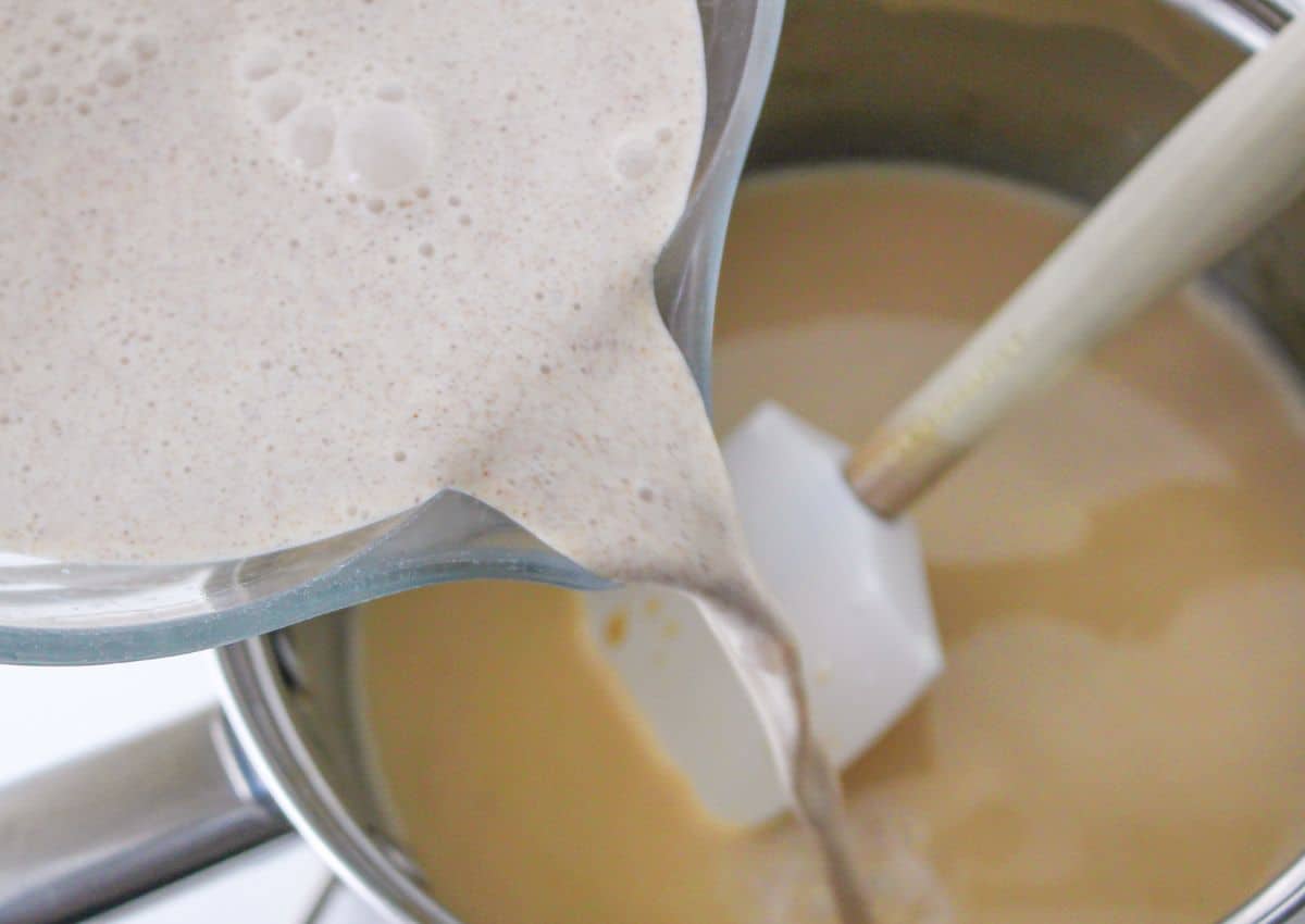 heavy cream and cinnamon mixture being added to the melted butter and brown sugar.