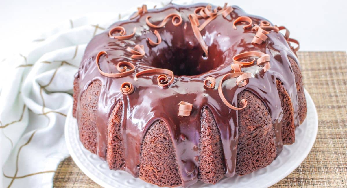 uncut chocolate sour cream bundt cake on a plate.