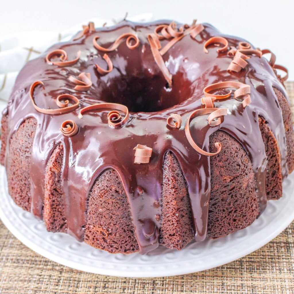 uncut chocolate sour cream bundt cake on a plate.
