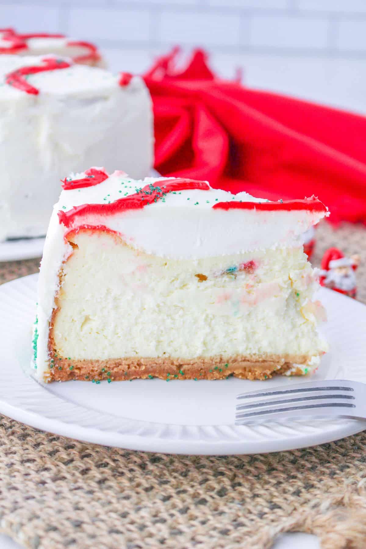 slice of little debbie christmas tree cake cheesecake on a plate.