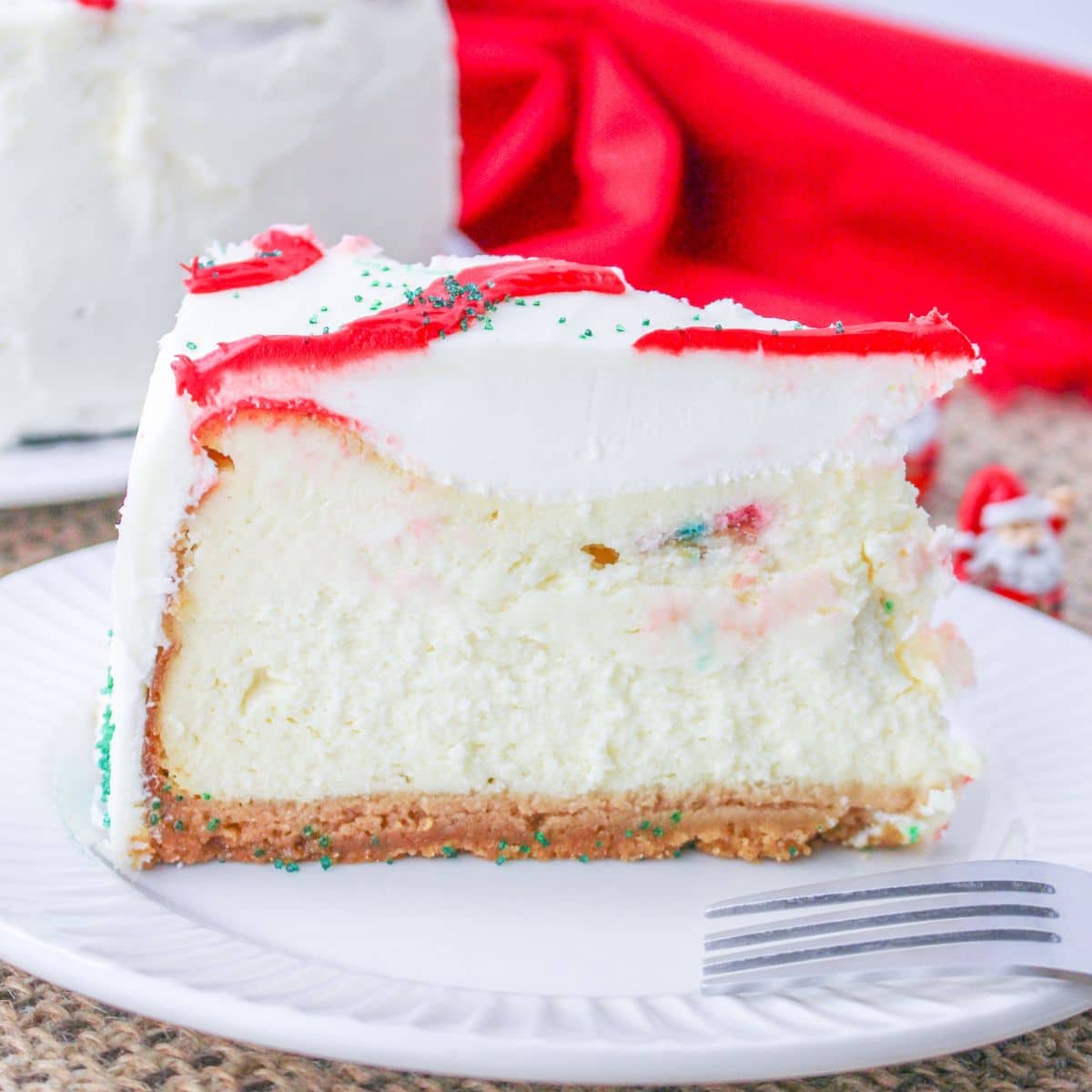 slice of little debbie christmas tree cake cheesecake on a plate.