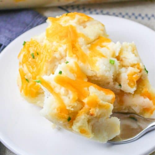 plate with a scoop of cheese mashed potato casserole.