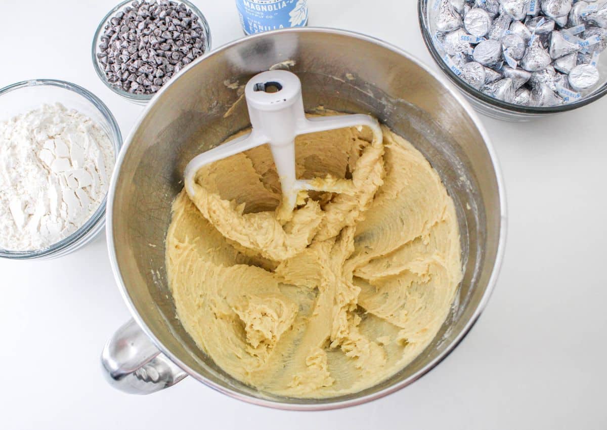 butter and sugars being creamed together in a stand mixer bowl.