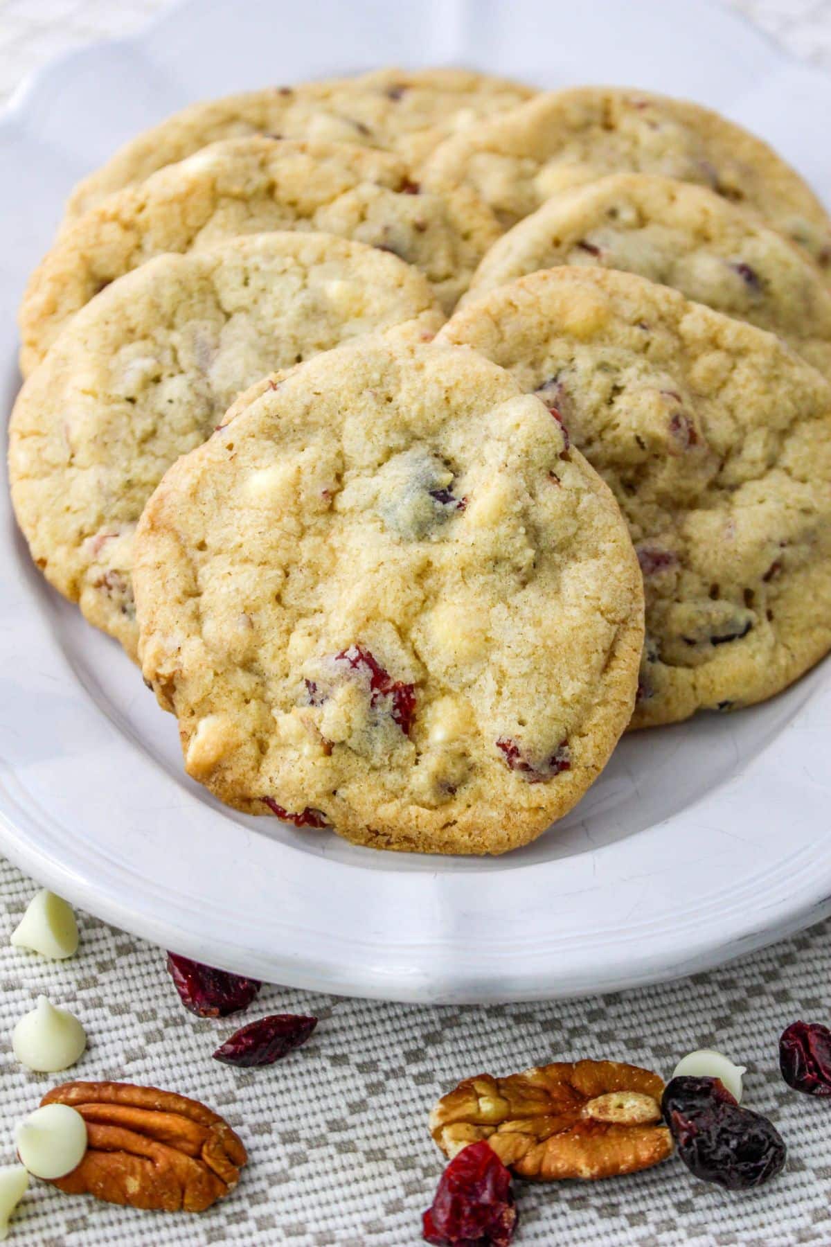 six cranberry pecan cookies on a plate.