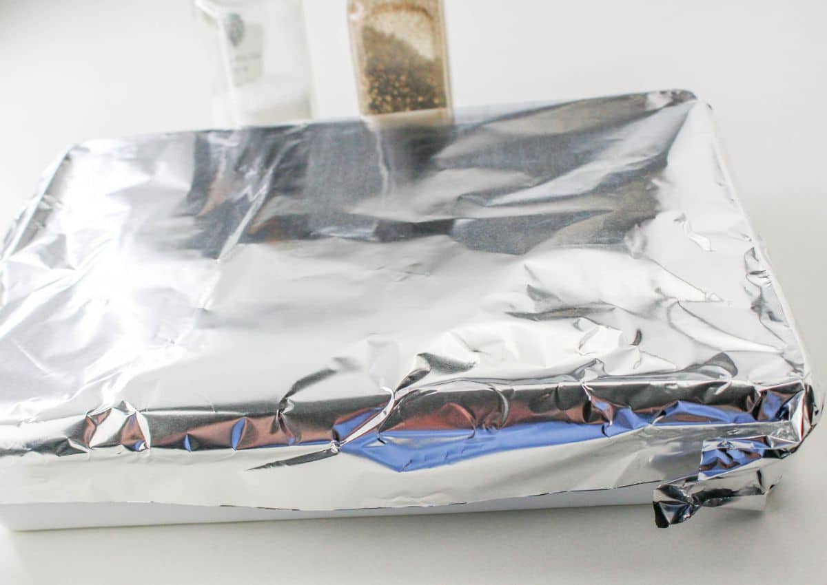 aluminum foil covered casserole dish on the table
