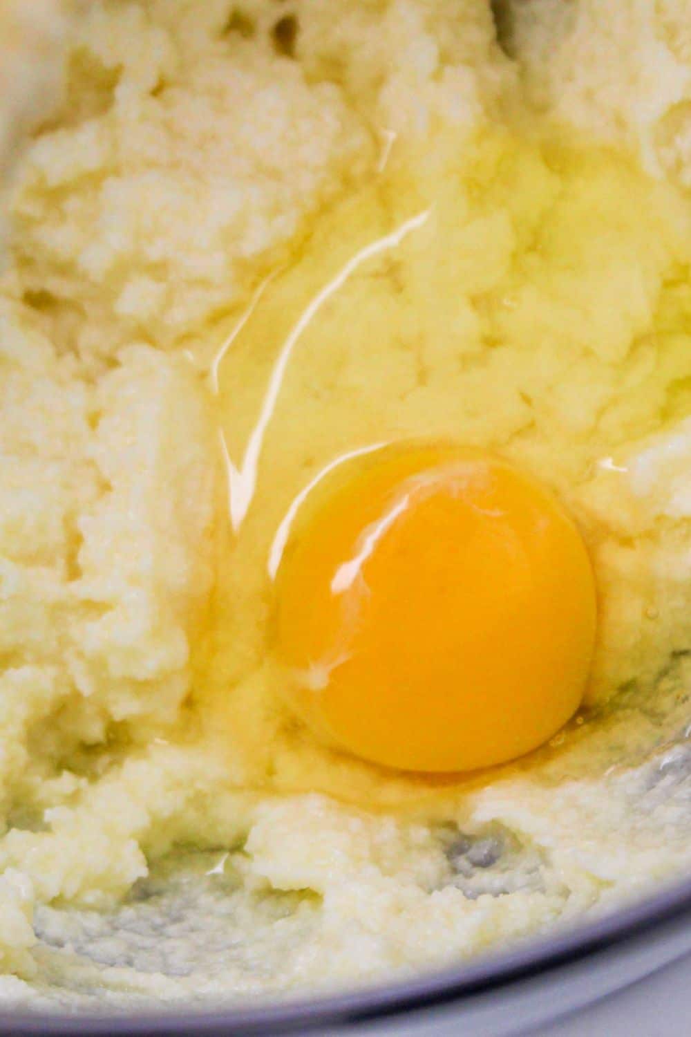 egg in a bowl with cream ed butter and sugar