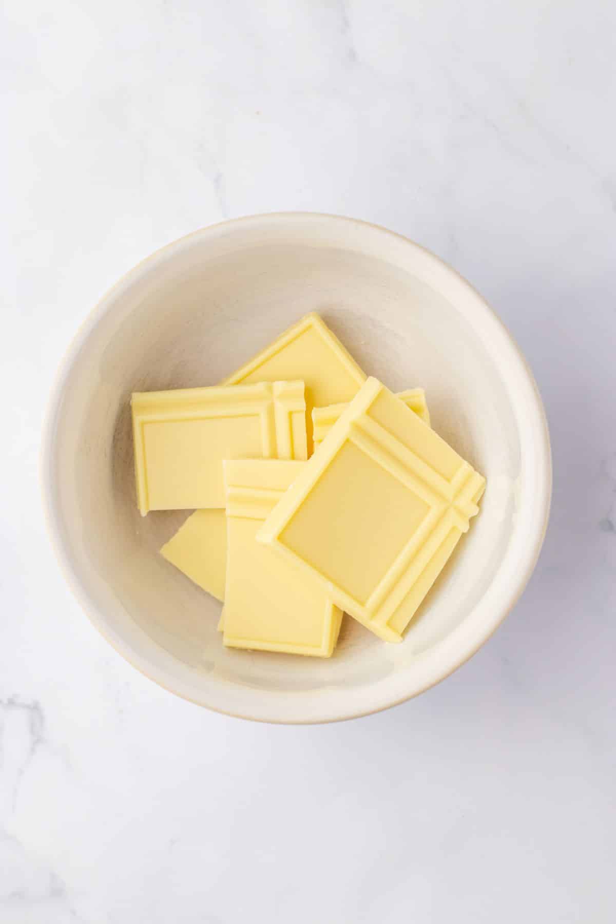 pieces of white chocolate in a small bowl ready to be melted.