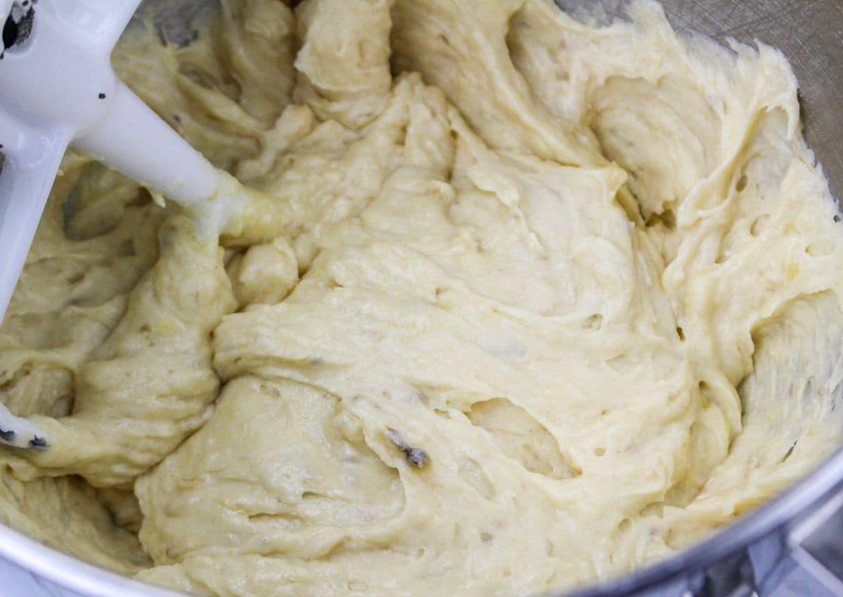 butter, sugar, and buttermilk being creamed in a mixer.