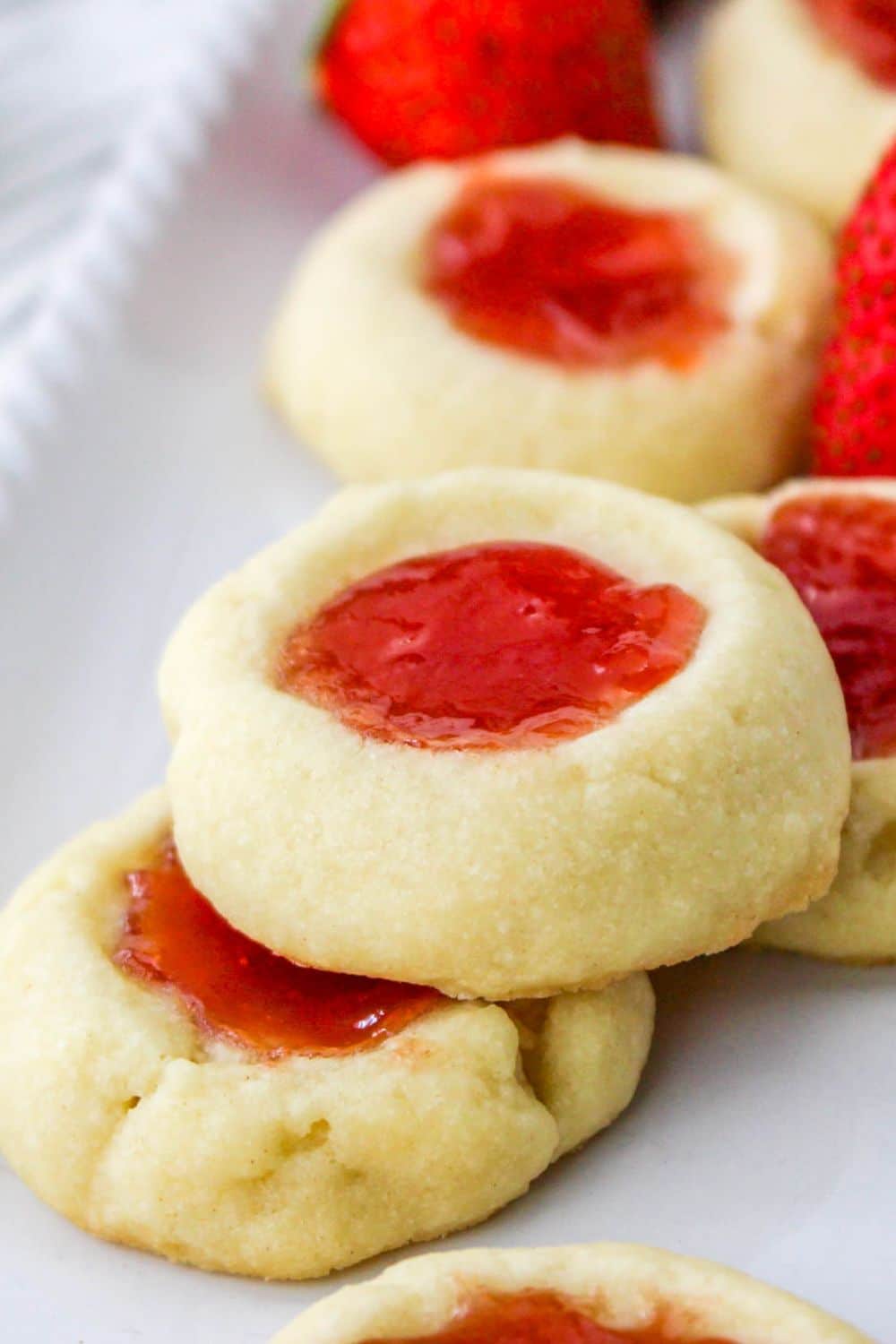 Strawberry Shortbread Cookies on a white tray, that the cookies are stacked on top of each other