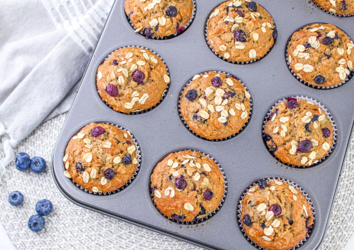 baked banana blueberry oatmeal muffins baked in a muffin pan.