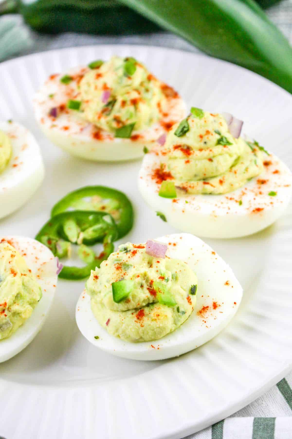 five mexican deviled eggs on plate.
