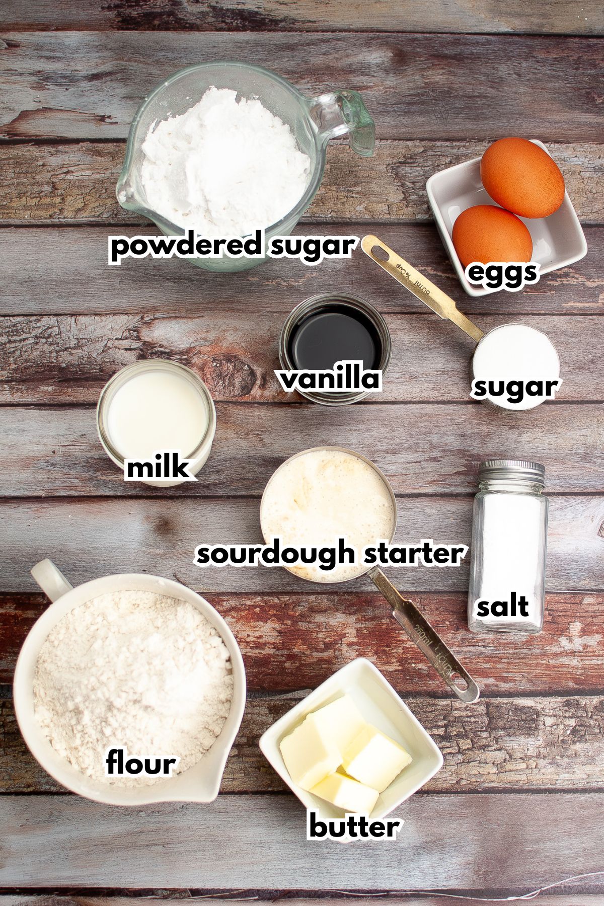 bowls of powdered sugar, eggs, vanilla, milk, sugar, sourdough starter, slat, flour, and butter.