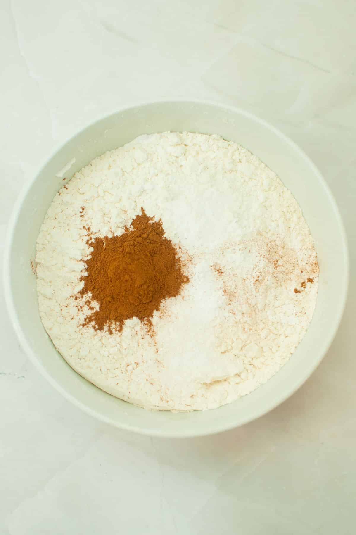dry ingredients being mixed in a large mixing bowl.