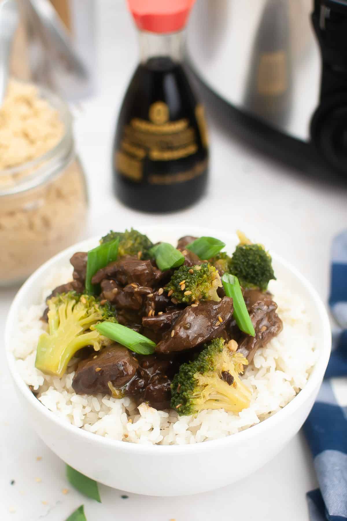 teriyaki beef served on top of a bed of white rice.