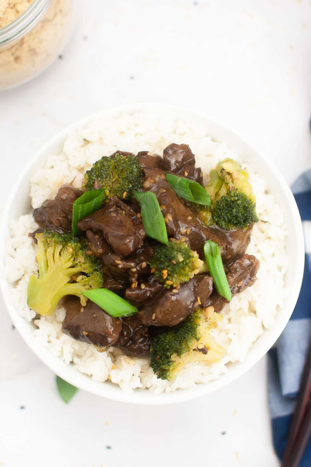 teriyaki beef served on top of a bed of white rice.