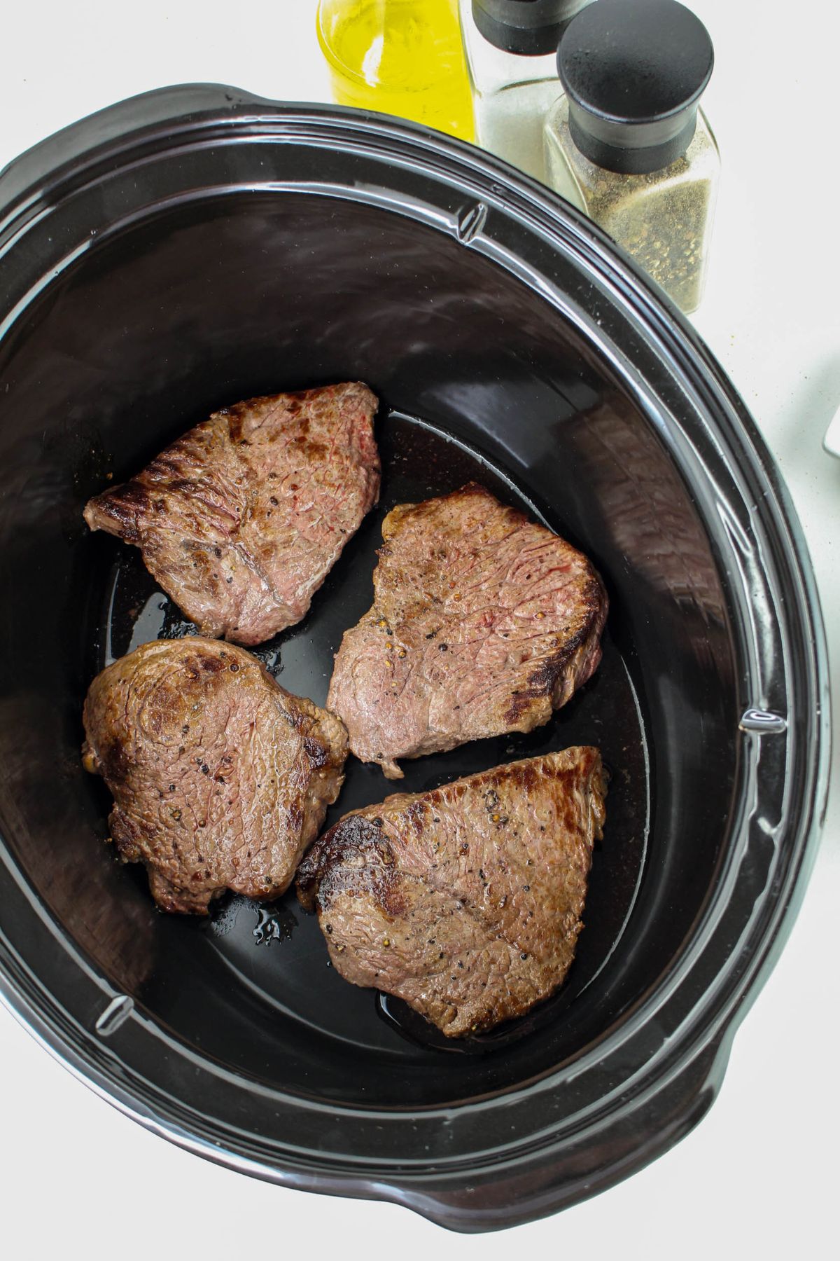 seared steaks in a slow cooker.