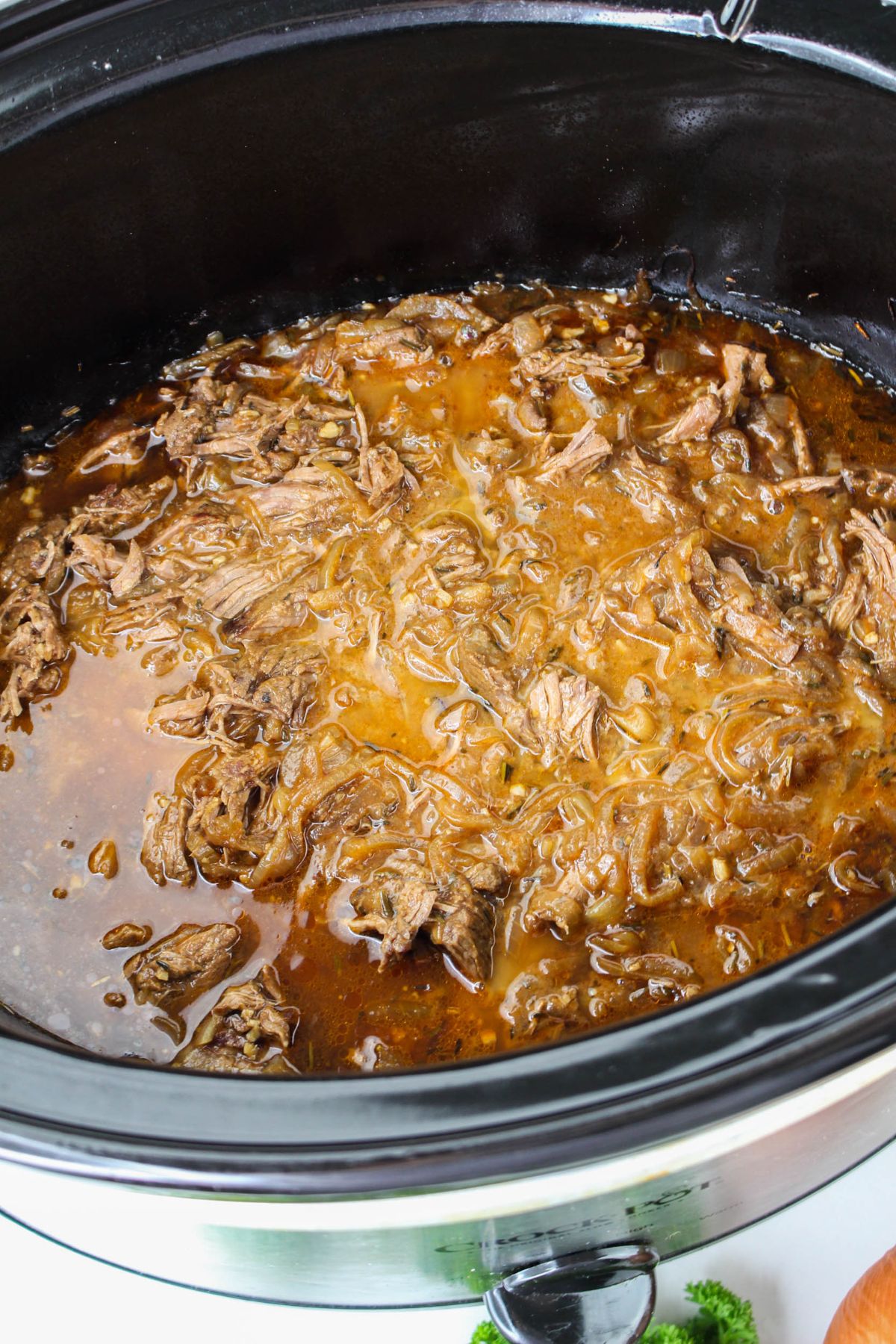 braised steak and onions in a slow cooker.