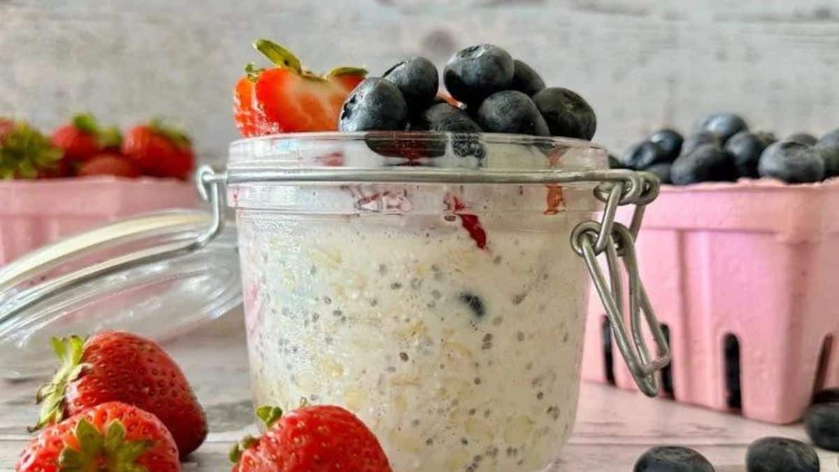 A jar of overnight oats with assorted berries.