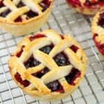 mini blueberry pie cooling on a wire rack.