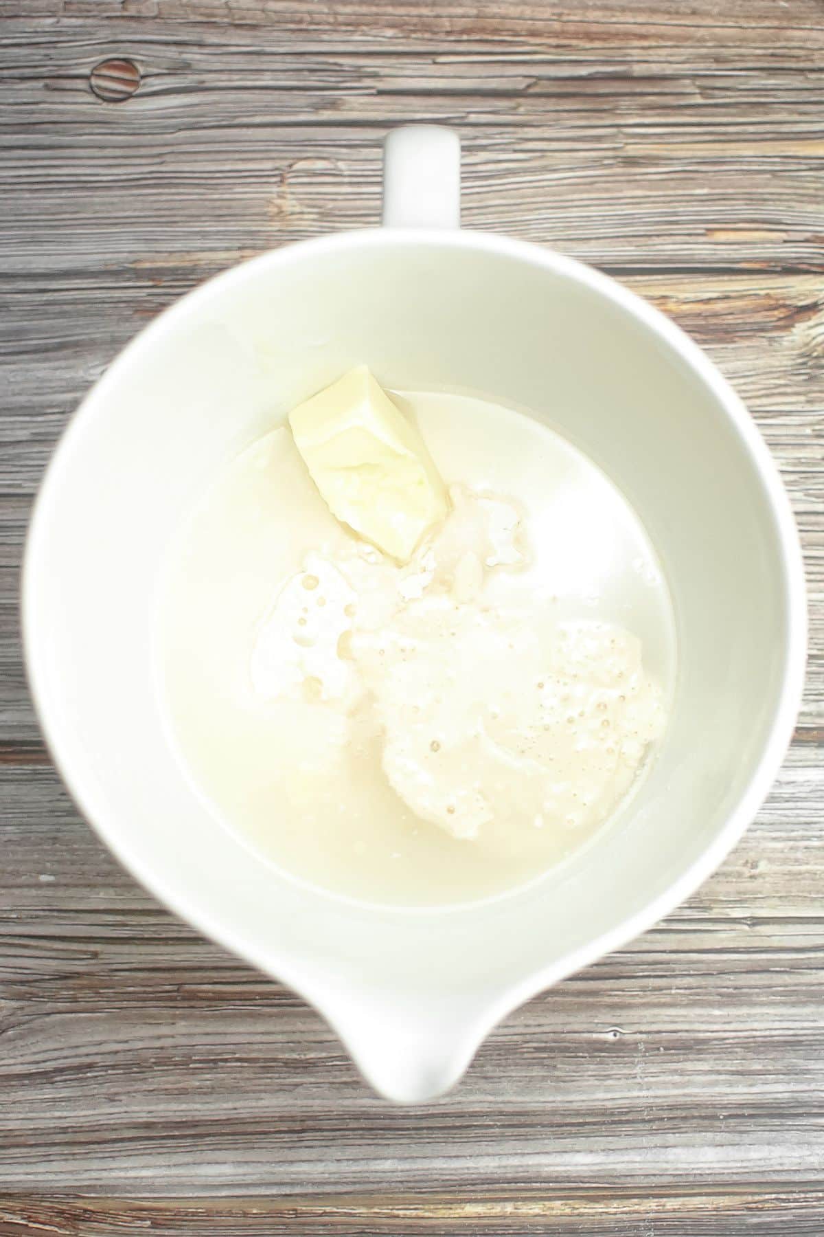 ingredients for sourdough bread in a mixing bowl.