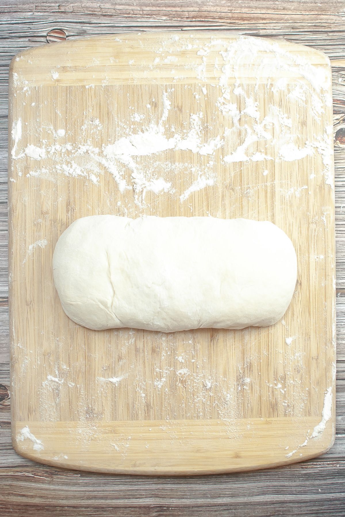 shape of sourdough on a wooden cutting board.