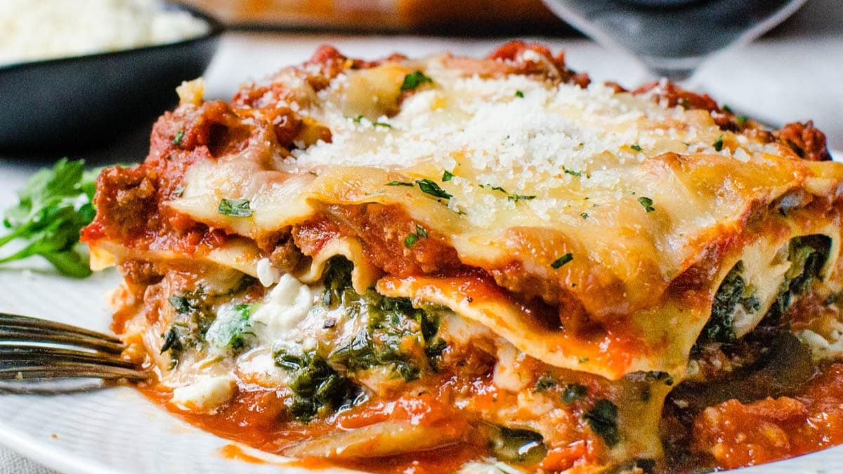 A saucy and cheesy serving of cottage cheese and spinach lasagna.