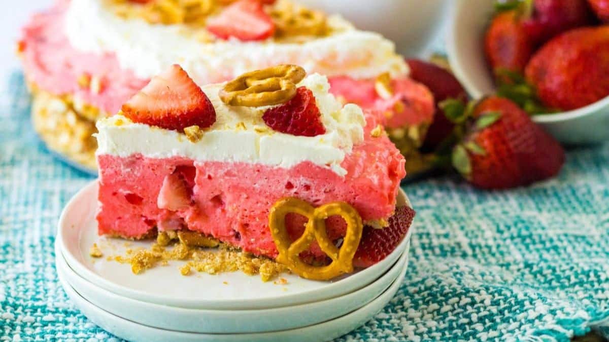 slice of no bake strawberry pretzel pie on a small plate.